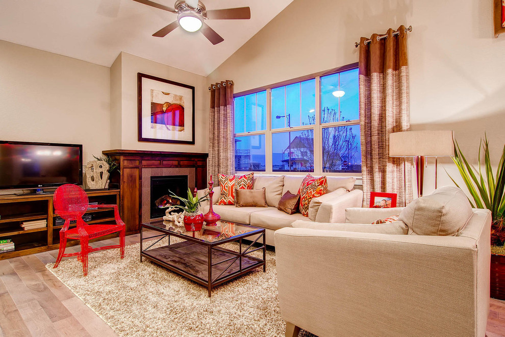 Inspiration for a timeless living room remodel in Denver with beige walls, a standard fireplace and a tv stand