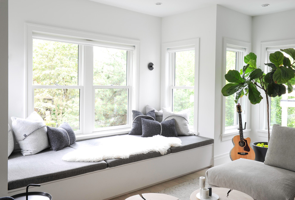 Inspiration for a medium sized scandi open plan living room in Vancouver with white walls and light hardwood flooring.