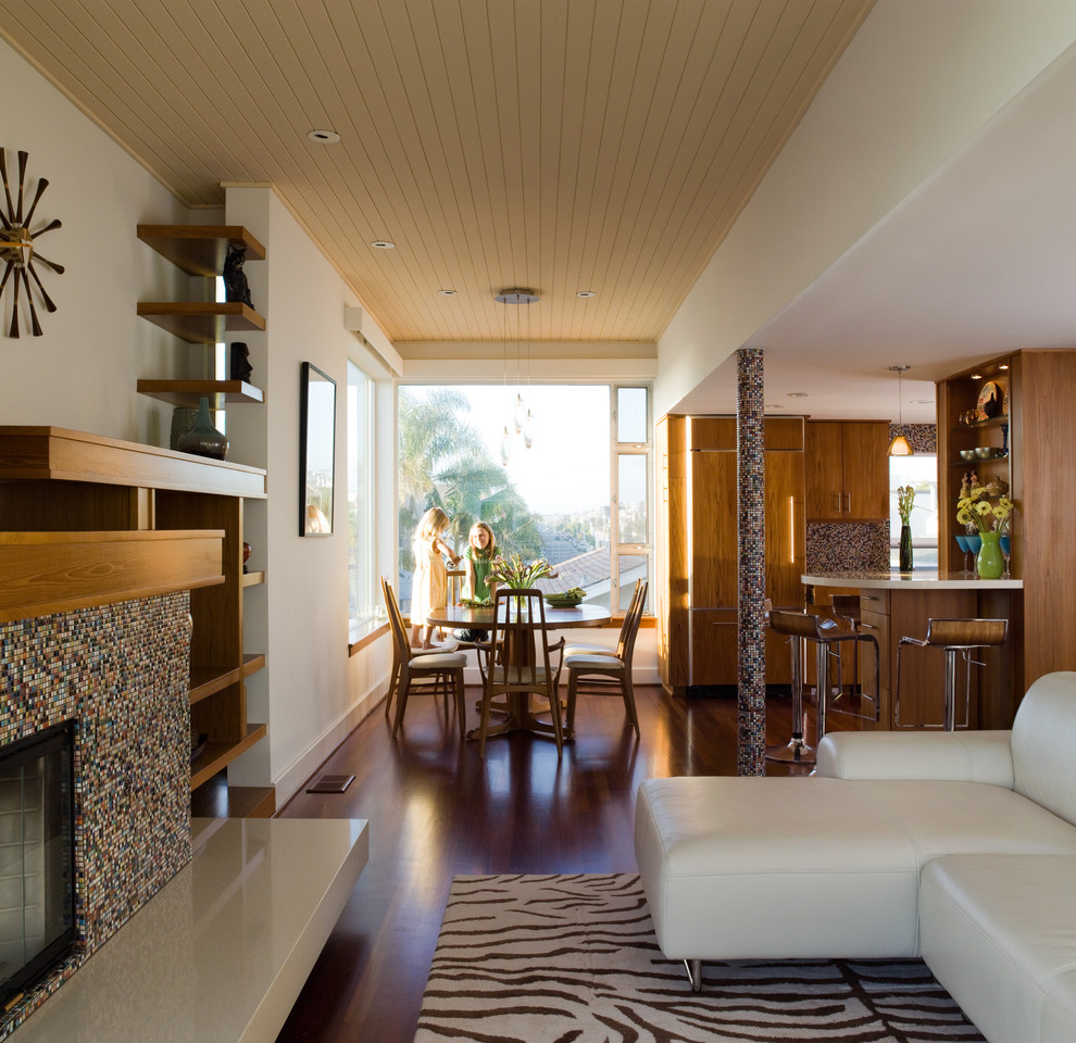 Стильный дизайн: открытая гостиная комната в морском стиле с фасадом камина из плитки - последний тренд