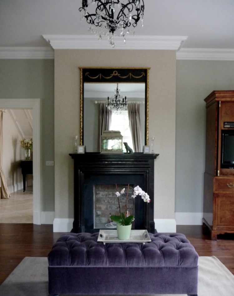 Photo of a medium sized traditional formal living room in London with dark hardwood flooring, a standard fireplace and a stone fireplace surround.