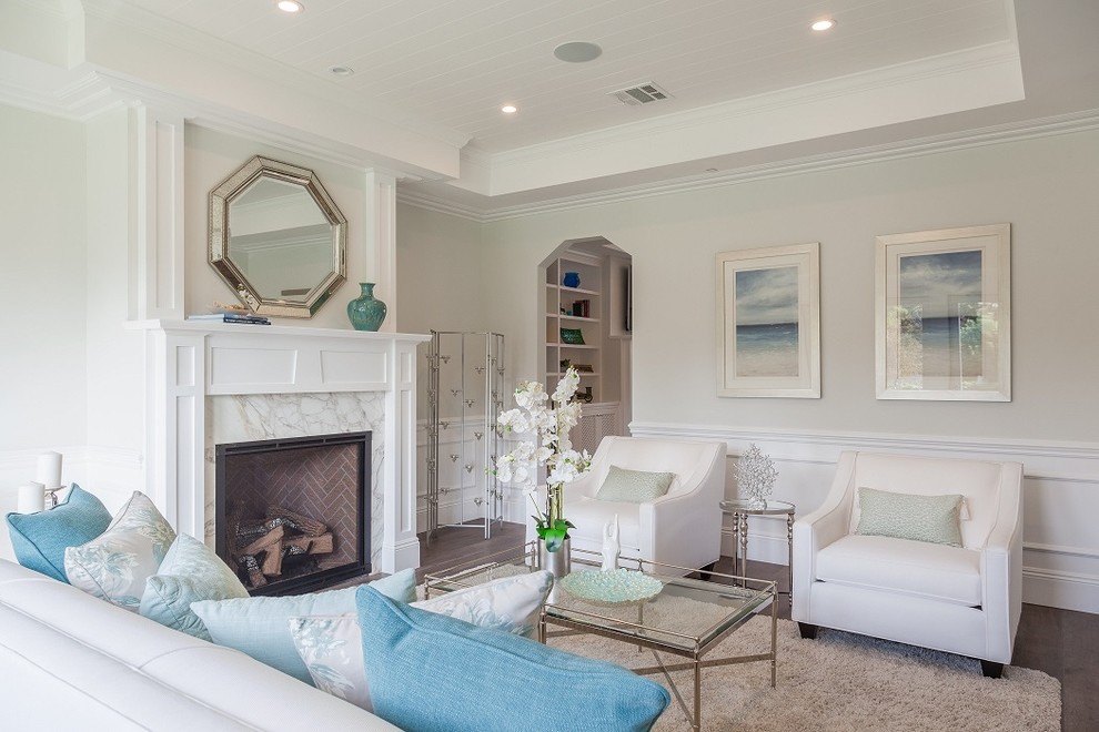 Medium sized nautical formal enclosed living room in Los Angeles with white walls, medium hardwood flooring, a standard fireplace, a stone fireplace surround and no tv.