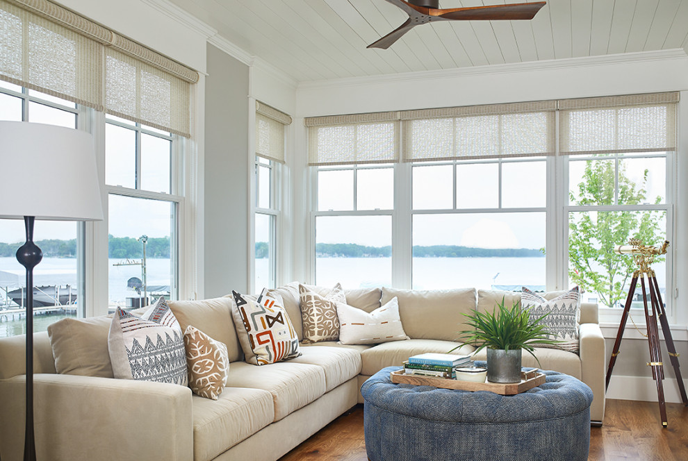 Living room - coastal medium tone wood floor living room idea in Grand Rapids with white walls