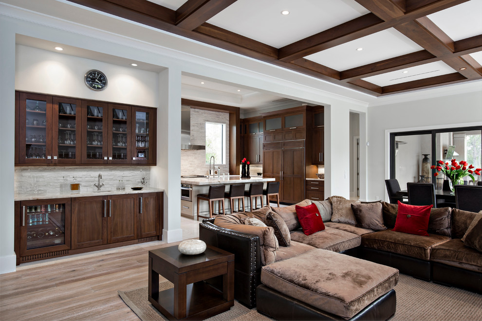 Large trendy open concept light wood floor living room photo in Miami with a bar and gray walls