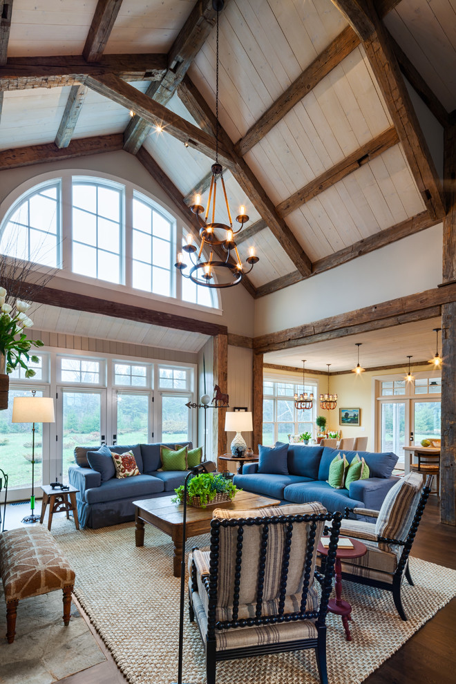 Inspiration for a mid-sized farmhouse open concept dark wood floor and brown floor living room remodel in Other with beige walls, a standard fireplace and a stone fireplace