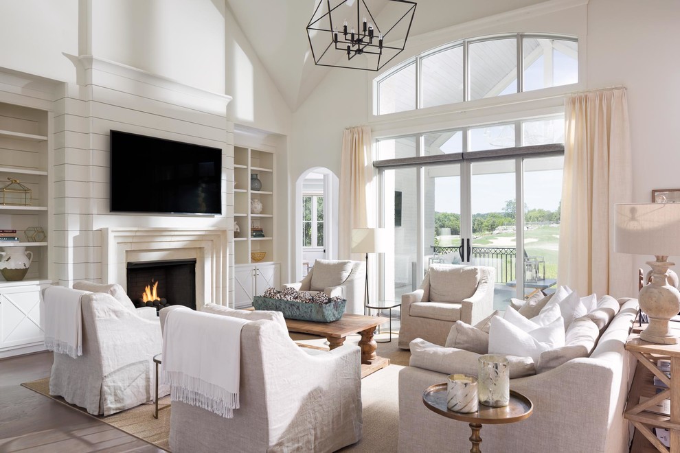 Inspiration pour un grand salon design ouvert avec un mur blanc, parquet clair, une cheminée standard, un manteau de cheminée en bois, un téléviseur fixé au mur et un sol beige.