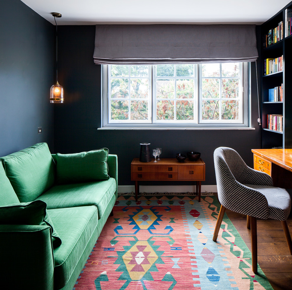 Inspiration for a small enclosed living room in London with black walls, dark hardwood flooring and brown floors.