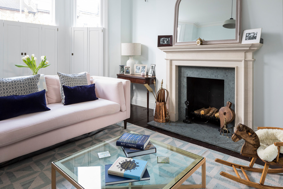 Large classic formal open plan living room in London with blue walls, dark hardwood flooring, a wood burning stove, a plastered fireplace surround, a wall mounted tv and brown floors.
