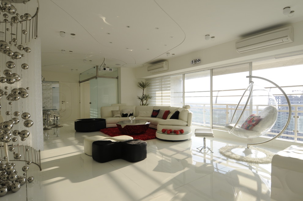 Photo of an expansive modern living room in Mumbai with white walls and marble flooring.