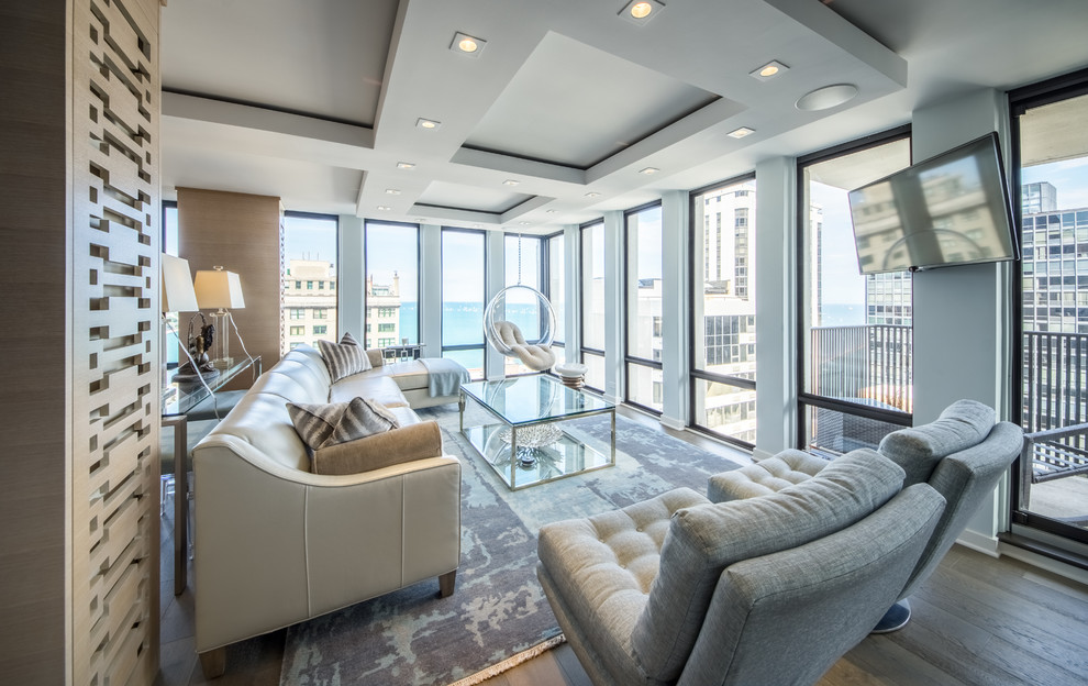 Contemporary open plan living room in Chicago with dark hardwood flooring, a wall mounted tv and brown floors.