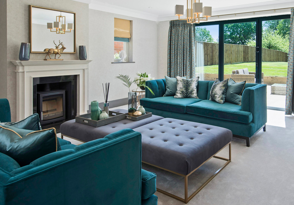 This is an example of a medium sized traditional formal and grey and teal living room in Surrey with grey walls, carpet, a wood burning stove and grey floors.