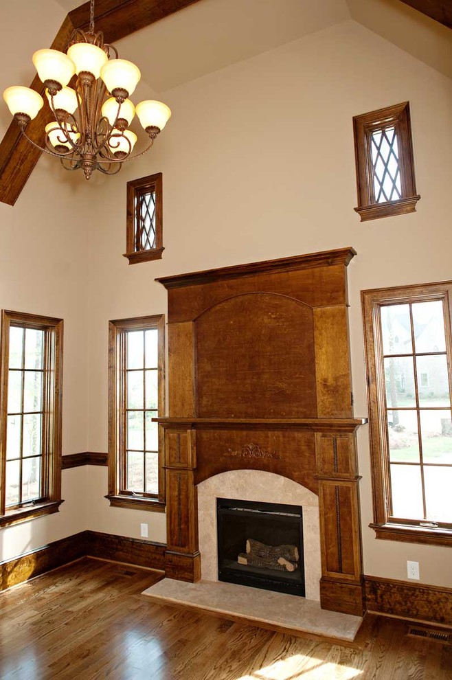 Idéer för att renovera ett vintage vardagsrum, med ett finrum, beige väggar, mellanmörkt trägolv, en standard öppen spis och en spiselkrans i trä