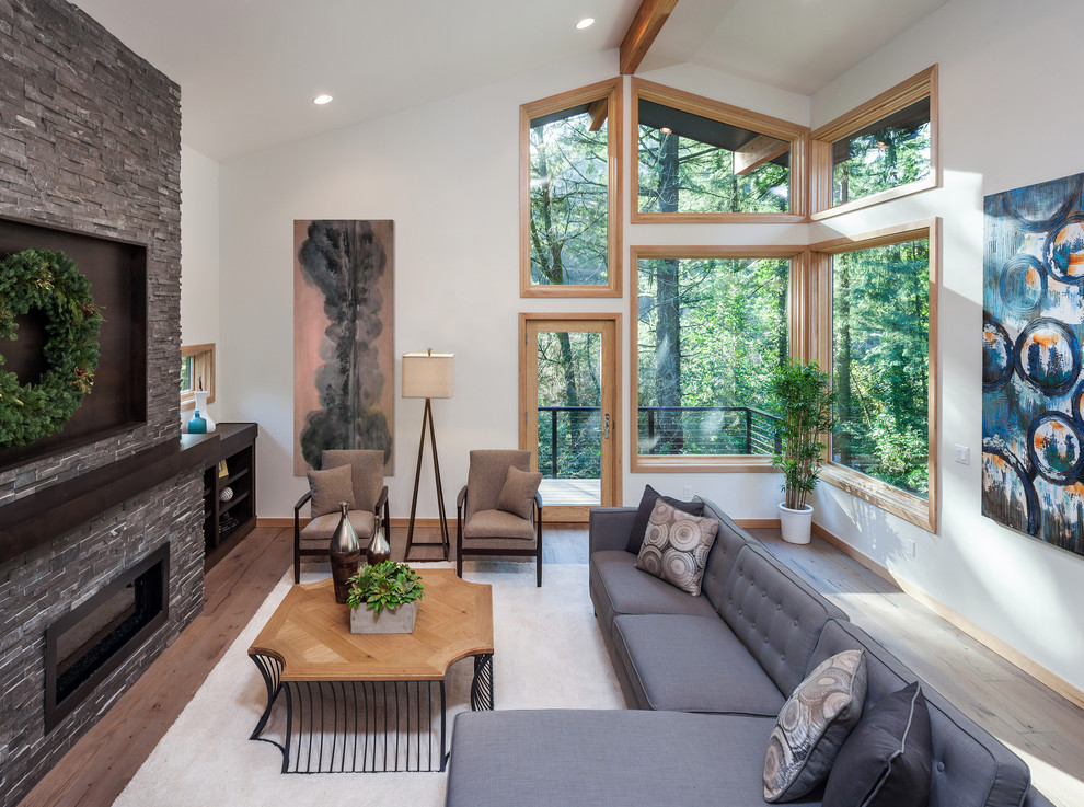 Inspiration for a midcentury formal living room in Portland with white walls, light hardwood flooring, a ribbon fireplace, a stone fireplace surround and no tv.