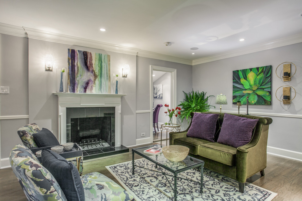 Photo of a small traditional formal and grey and purple living room in Dallas with grey walls, medium hardwood flooring, a standard fireplace, a tiled fireplace surround, no tv, brown floors and a dado rail.