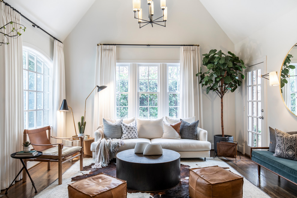Inspiration for a transitional medium tone wood floor and brown floor living room remodel in Dallas with white walls
