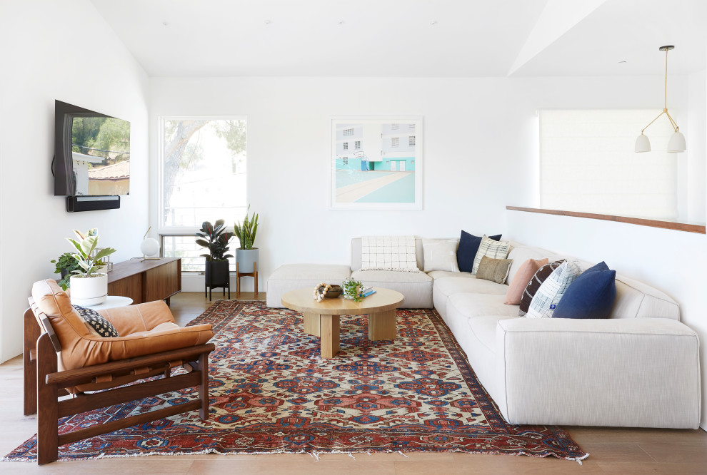 Living room - contemporary open concept medium tone wood floor and brown floor living room idea in Los Angeles with white walls and a wall-mounted tv