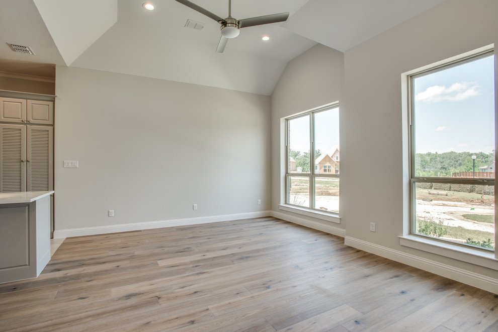 This is an example of a medium sized classic open plan living room in Dallas with grey walls and plywood flooring.