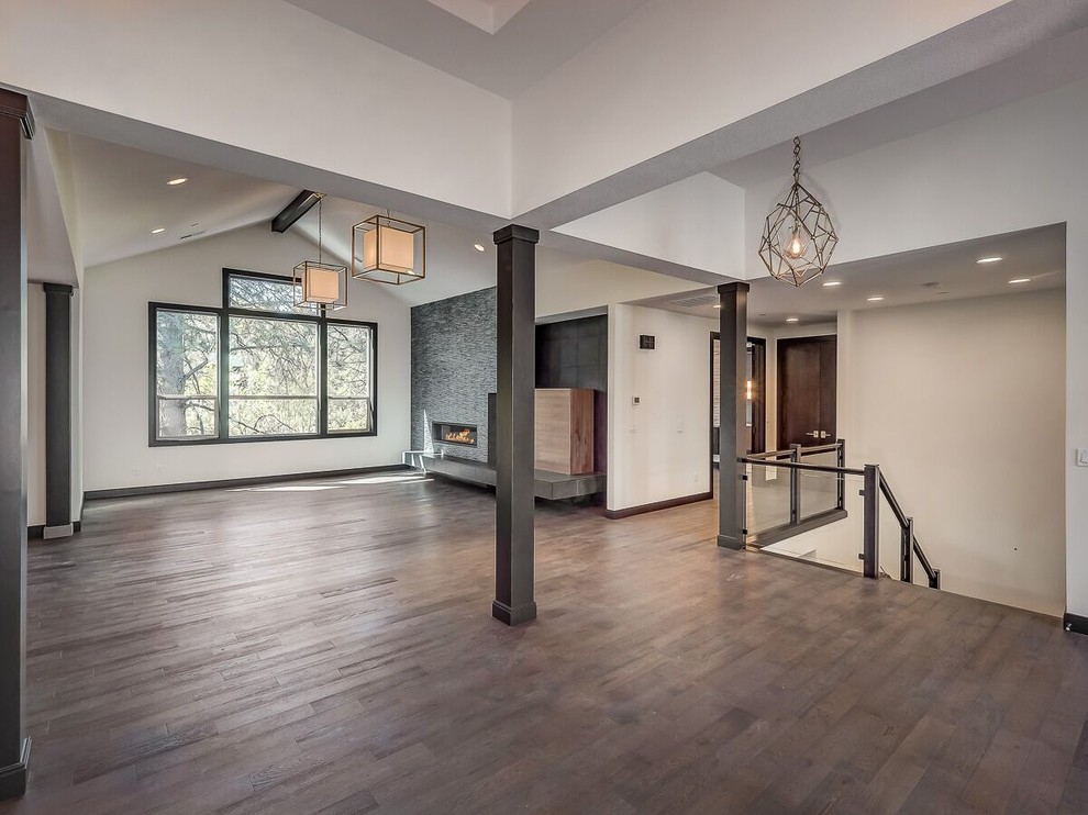 This is an example of a large modern open plan living room in Portland with white walls, dark hardwood flooring, a ribbon fireplace, a tiled fireplace surround, no tv and brown floors.