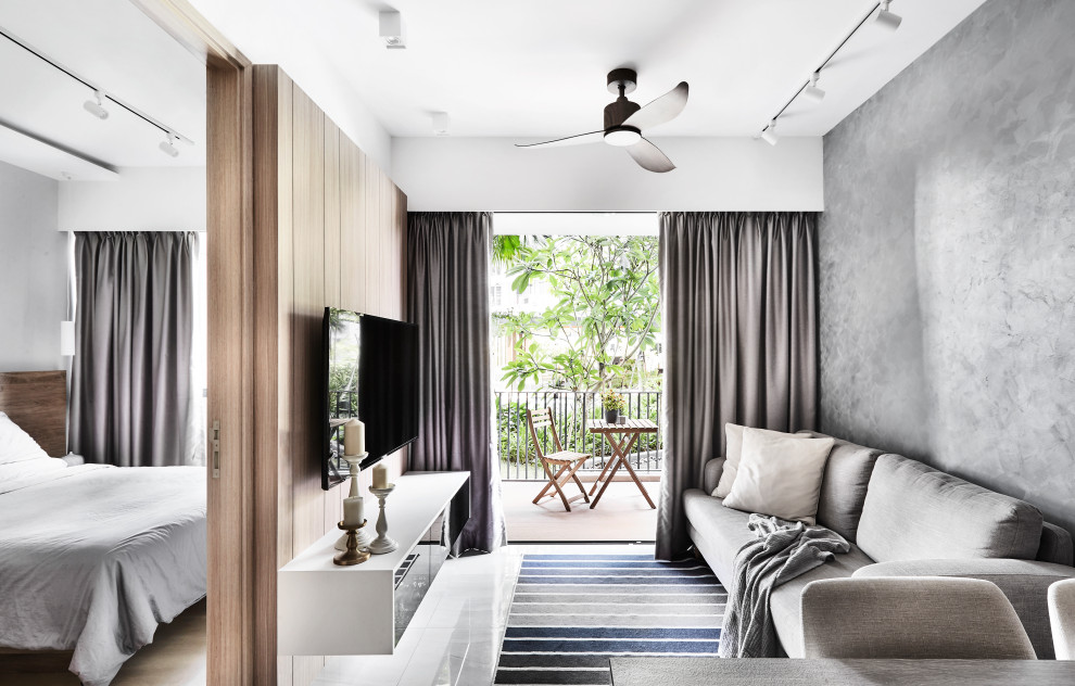 Scandi living room in Singapore with grey walls, a wall mounted tv and white floors.