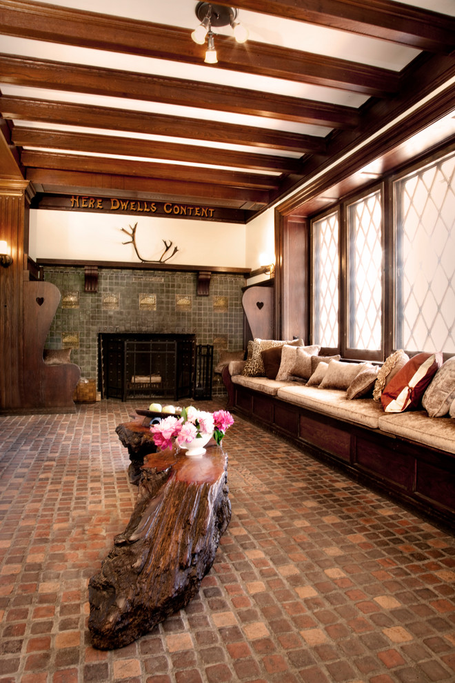 Идея дизайна: гостиная комната в классическом стиле с кирпичным полом, стандартным камином и фасадом камина из плитки без телевизора
