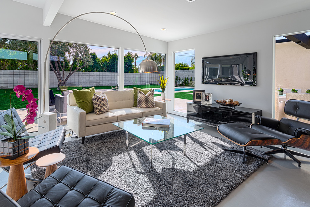 Immagine di un soggiorno minimalista con sala formale e TV a parete