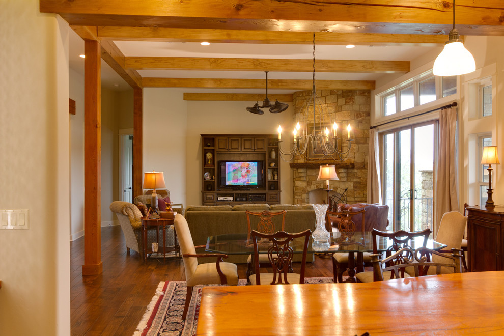 Example of a large arts and crafts open concept and formal medium tone wood floor and brown floor living room design in Austin with beige walls, a corner fireplace, a stone fireplace and a media wall