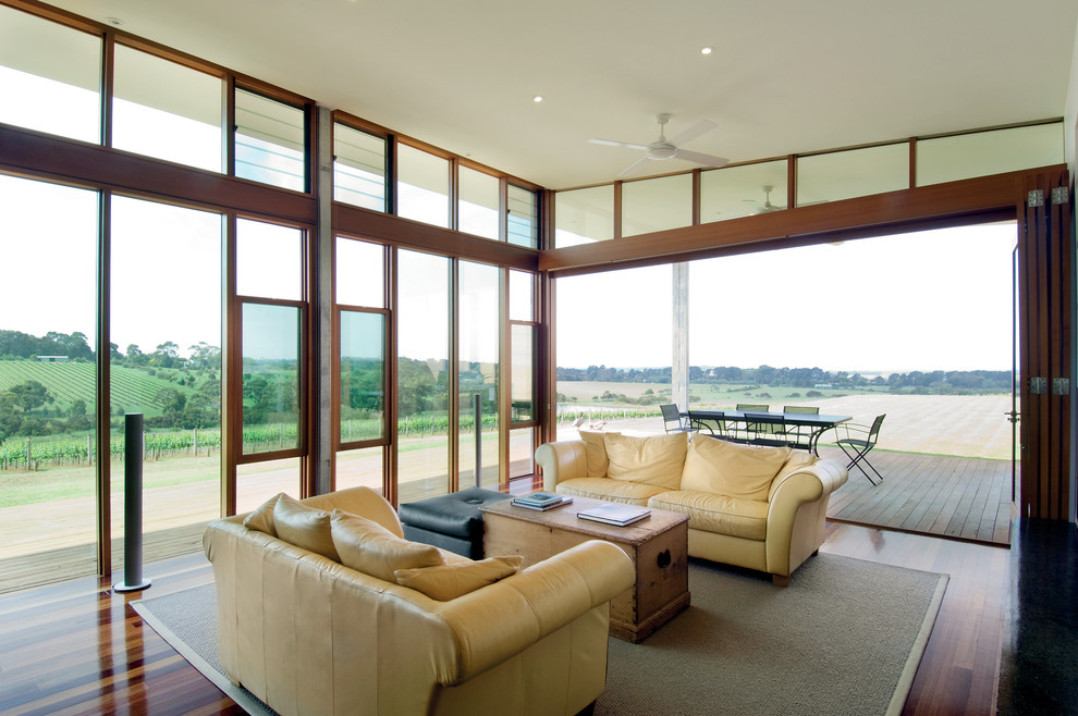 Inspiration for a large modern open plan living room in Melbourne with dark hardwood flooring.