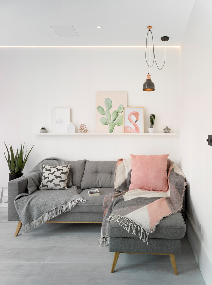 Scandi grey and pink living room in London with white walls and grey floors.