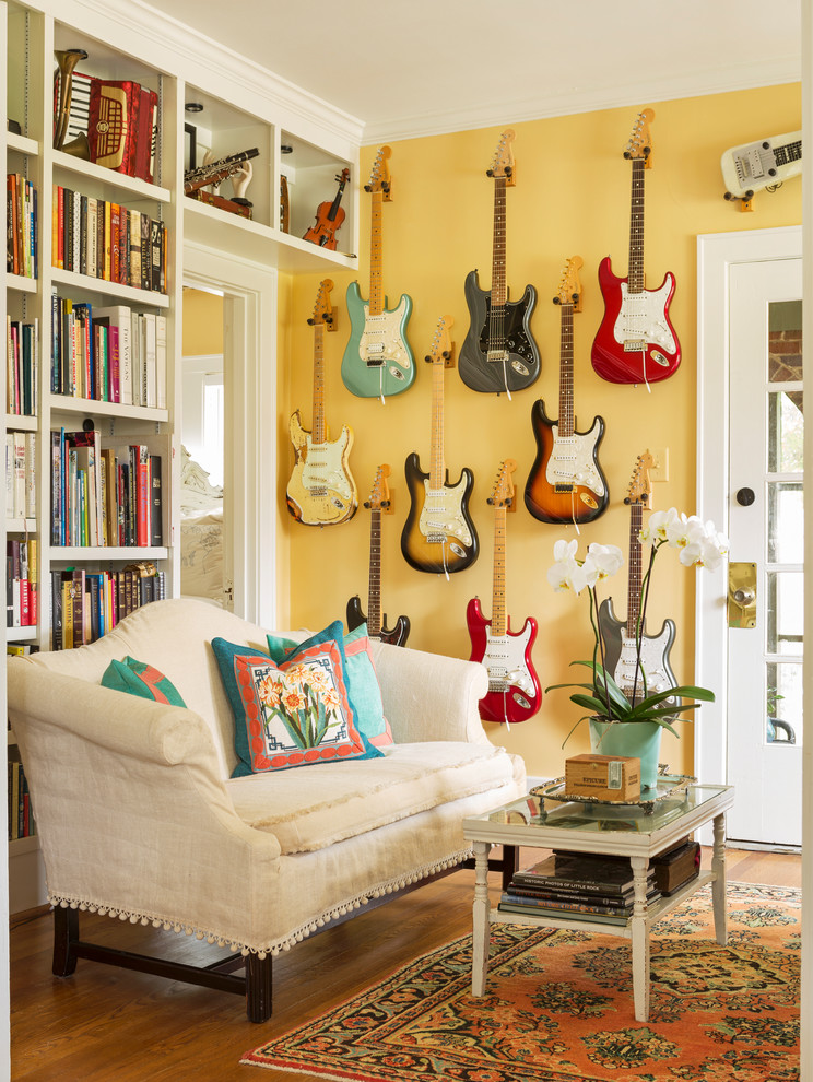 Living room - eclectic medium tone wood floor and brown floor living room idea in Little Rock with yellow walls