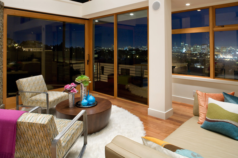 Photo of a large contemporary formal mezzanine living room in San Francisco with white walls, no fireplace, no tv, medium hardwood flooring and brown floors.