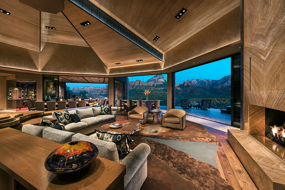 Inspiration for a huge contemporary open concept dark wood floor living room remodel in Other with a bar, beige walls, a standard fireplace, a stone fireplace and no tv