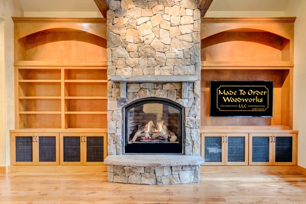 Example of a mid-sized transitional formal and enclosed light wood floor living room design in Orange County with beige walls, a standard fireplace, a stone fireplace and a media wall