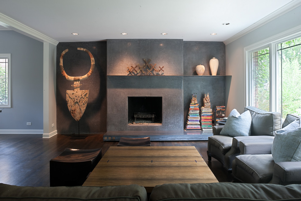 Inspiration for a mid-sized modern open concept dark wood floor living room library remodel in Chicago with gray walls, a standard fireplace, a concrete fireplace and no tv