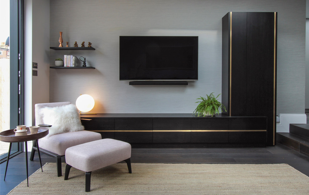 Large contemporary open plan living room in London with white walls, dark hardwood flooring, no fireplace and a wall mounted tv.