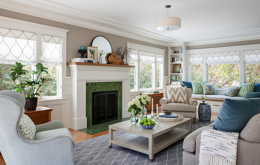 This is an example of a classic living room in San Francisco with grey walls, medium hardwood flooring, a tiled fireplace surround and brown floors.