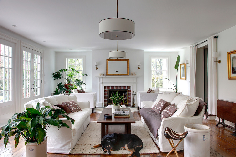 Large elegant living room photo in Bridgeport with white walls, a standard fireplace and a brick fireplace
