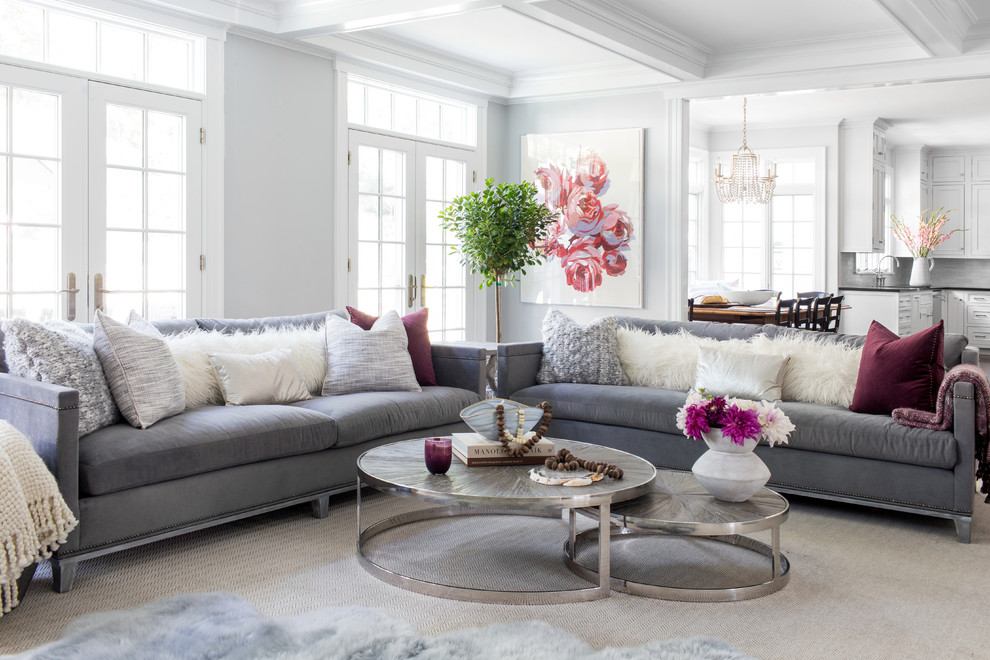 Photo of a medium sized nautical open plan living room in New York with grey walls, medium hardwood flooring, a standard fireplace, a wooden fireplace surround, a wall mounted tv and brown floors.