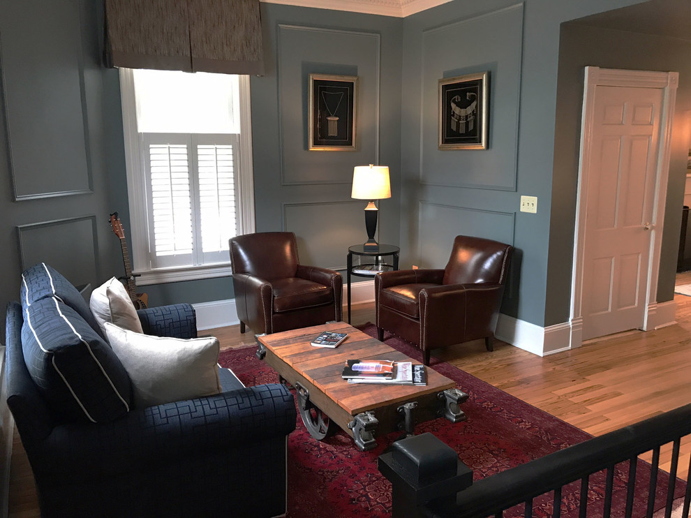 Medium sized classic formal enclosed living room in DC Metro with light hardwood flooring, no tv, blue walls and no fireplace.