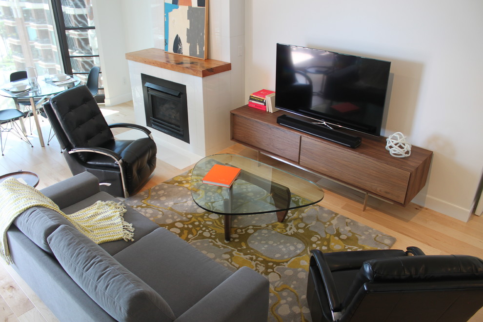 Small minimalist open concept light wood floor living room photo in San Diego with white walls, a standard fireplace, a tile fireplace and a tv stand