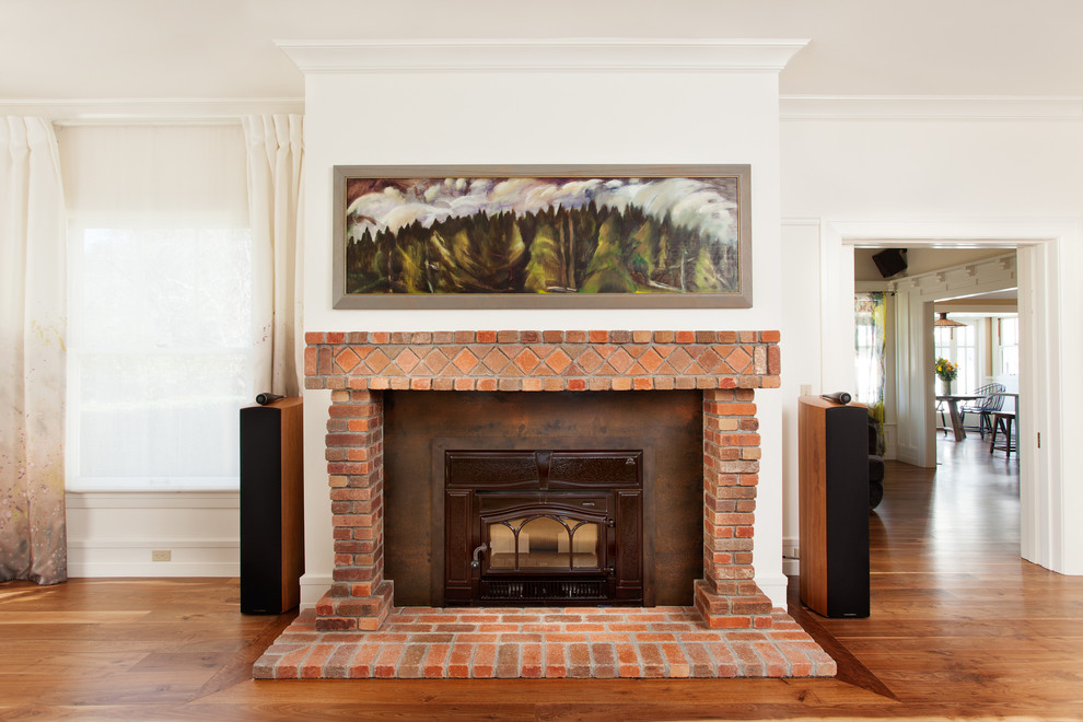 Elegant formal and open concept dark wood floor living room photo in San Luis Obispo with white walls, a standard fireplace and a brick fireplace