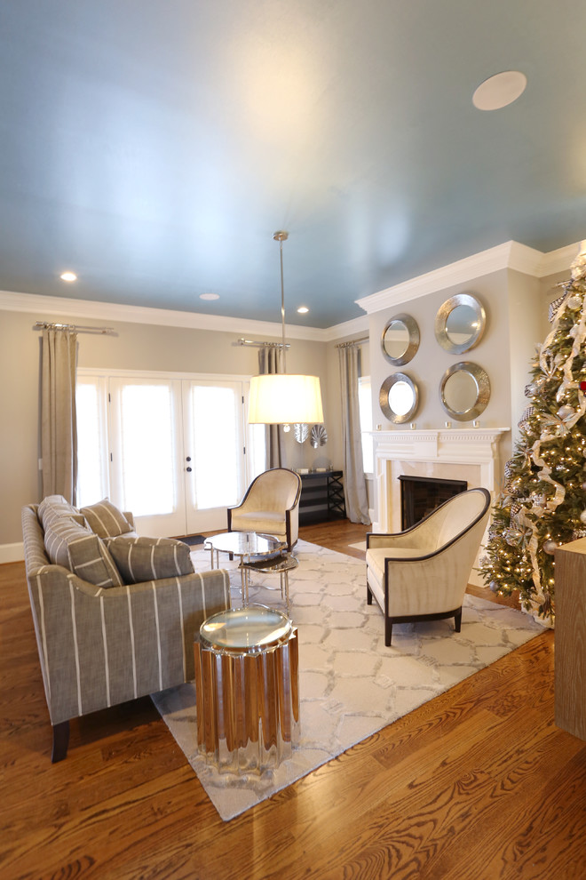 Photo of a medium sized classic formal and grey and teal enclosed living room in DC Metro with grey walls, medium hardwood flooring, a standard fireplace, a wooden fireplace surround and no tv.
