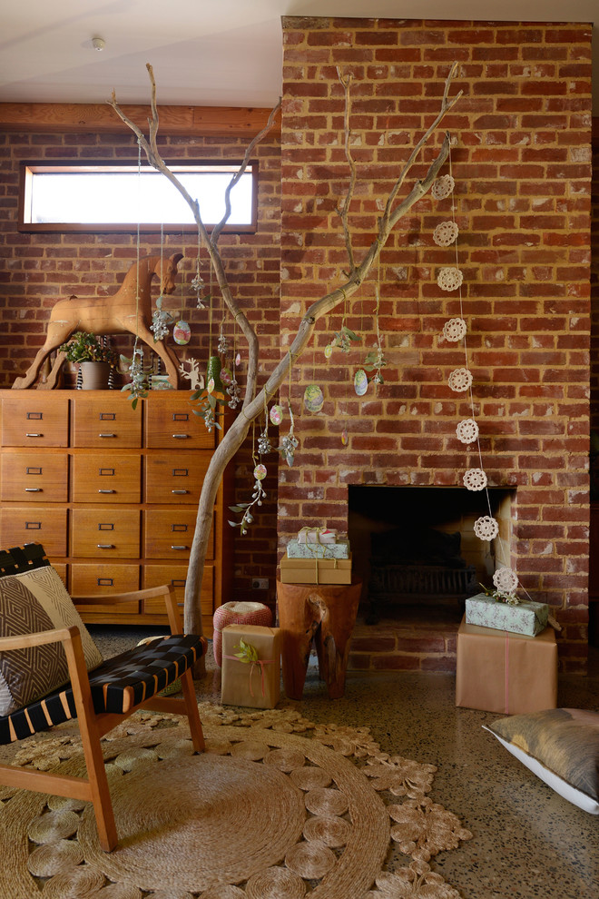 This is an example of an eclectic living room in Adelaide with a standard fireplace and a brick fireplace surround.