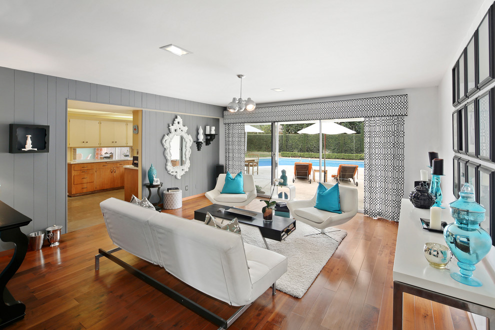 Retro living room in Orange County with grey walls, dark hardwood flooring, no tv and brown floors.