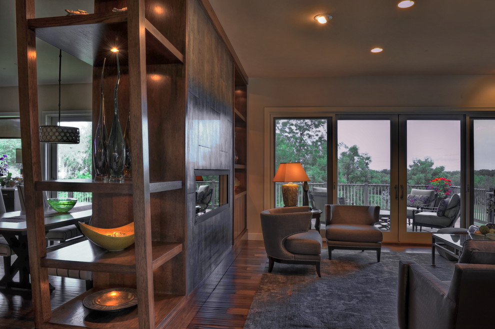 Идея дизайна: двухуровневая гостиная комната среднего размера в стиле неоклассика (современная классика) с домашним баром, коричневыми стенами, паркетным полом среднего тона, горизонтальным камином, фасадом камина из плитки и коричневым полом без телевизора