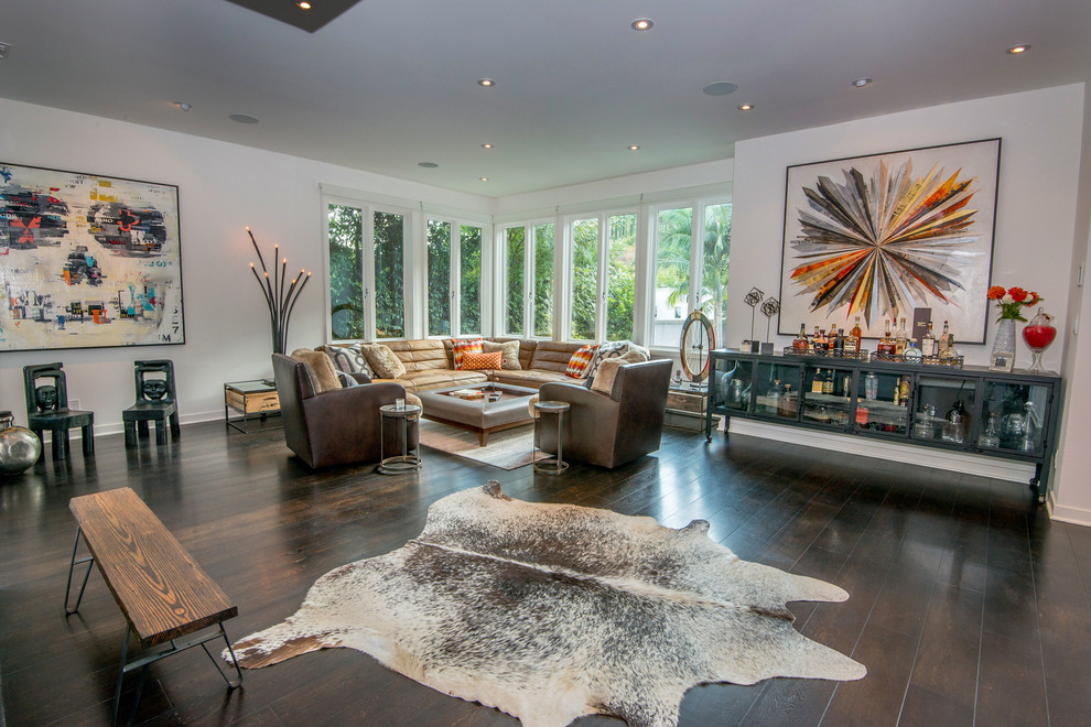 This is an example of a contemporary living room in Los Angeles with white walls and dark hardwood flooring.