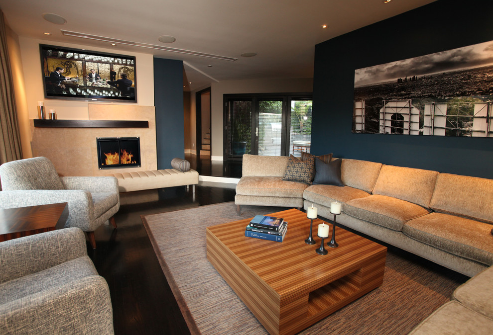 Photo of a medium sized contemporary open plan living room in Los Angeles with blue walls, dark hardwood flooring, a wall mounted tv and brown floors.