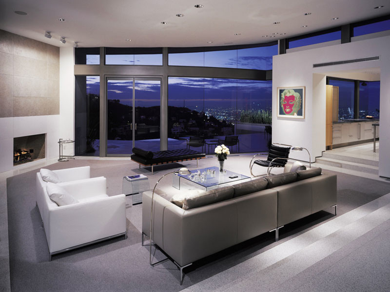 Свежая идея для дизайна: большая парадная, открытая гостиная комната в стиле модернизм с белыми стенами, стандартным камином и фасадом камина из камня без телевизора - отличное фото интерьера