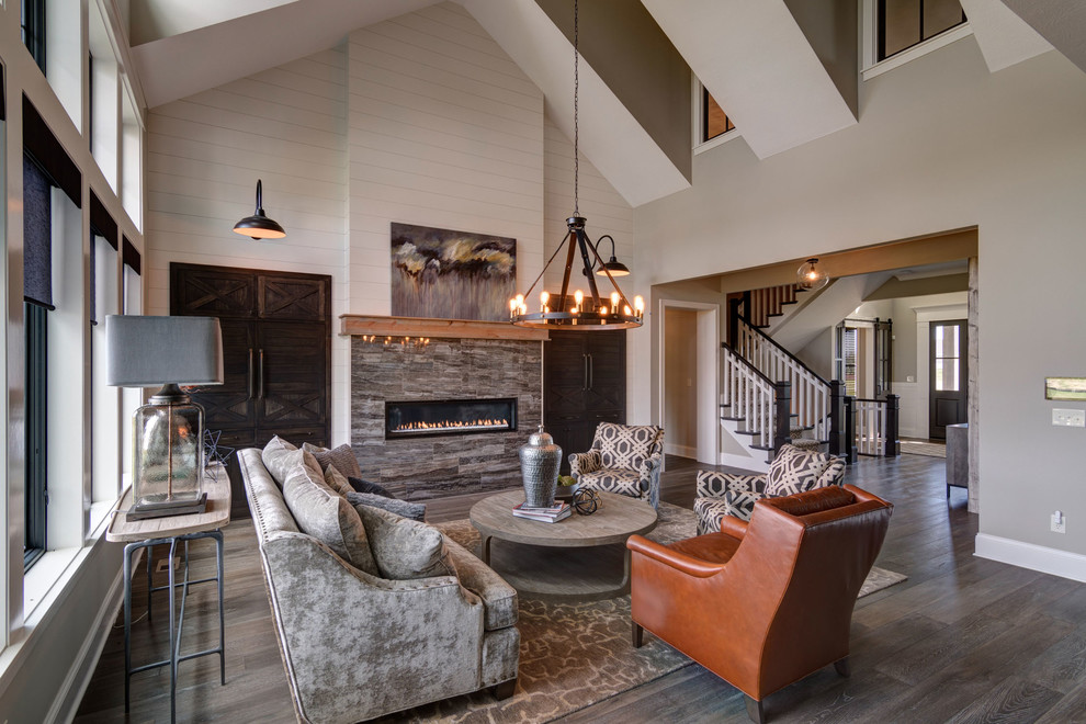 Inspiration for a farmhouse formal open plan living room in Indianapolis with beige walls, laminate floors, a ribbon fireplace, a tiled fireplace surround and feature lighting.