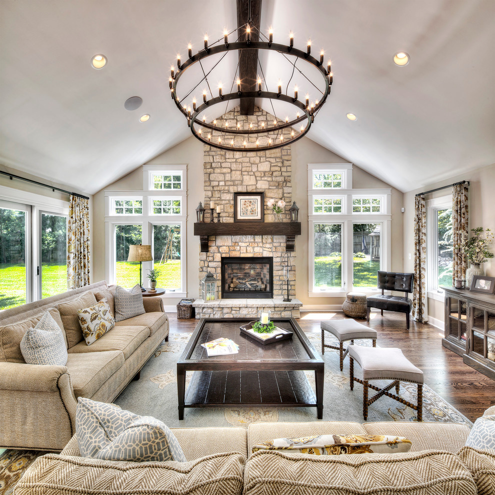 Example of a huge classic open concept and formal medium tone wood floor living room design in Kansas City with beige walls, a standard fireplace and a stone fireplace
