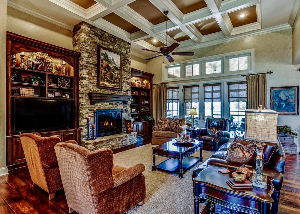 Photo of a large rustic formal open plan living room in Other with beige walls, dark hardwood flooring, a standard fireplace, a stone fireplace surround, no tv and brown floors.