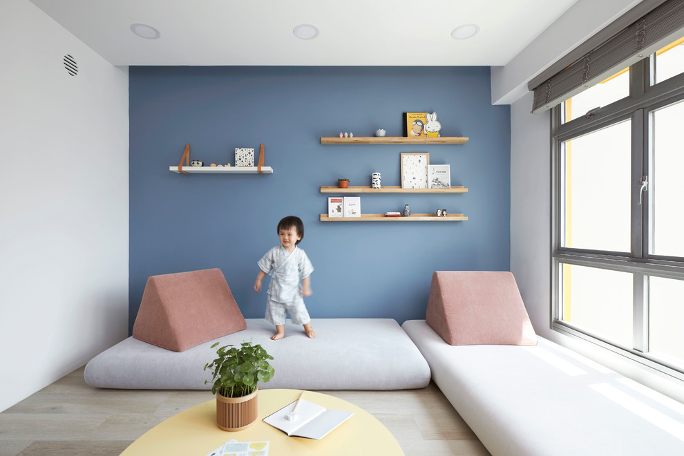 Inspiration for a contemporary light wood floor and beige floor family room remodel in Singapore with blue walls